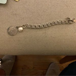John wind silver color bracelet with s initial tag and white cotton pearl ball